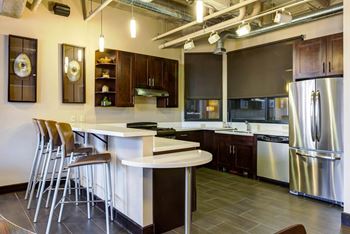 Resident lounge with kitchen, dining space and fireplace